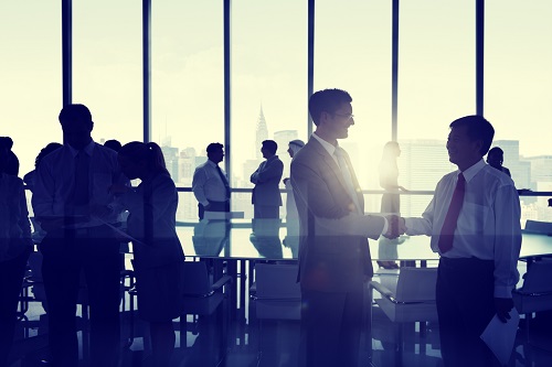 Group of People Shaking Hands at New York Skyline