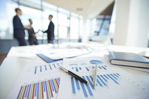 Spreadsheets with charts on office table